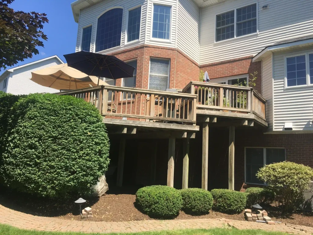 Composite decking vs wood decking - Photo of a wooden deck that shows wear from weatherization